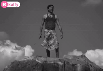 Man Standing on Rock Holding Knife With K Kulfy Logo