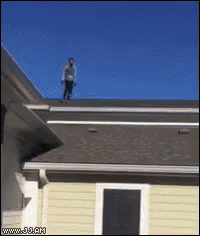 Man Standing on Roof of House