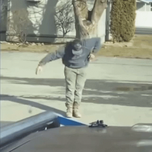 Man Standing on Sidewalk in Front of House