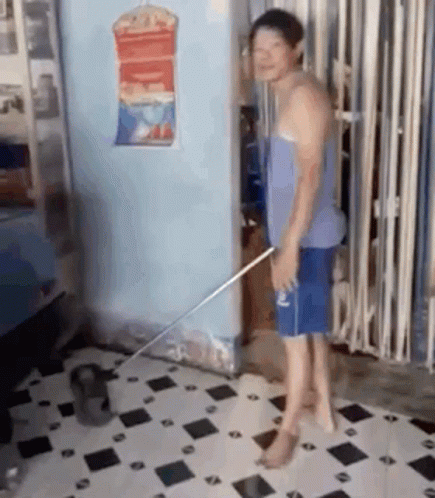 Man Standing on Tiled Floor With Mop
