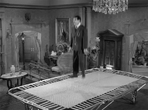Man Standing On Trampoline Black And White GIF