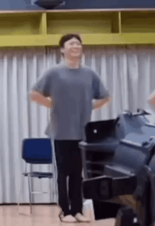 Man Standing With Hands on Hips Laughing