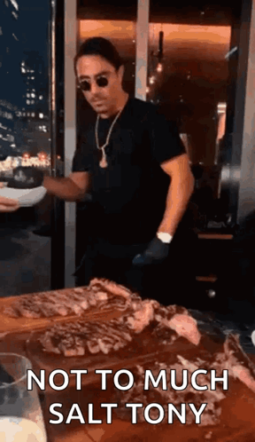 Man Standing With Plate and Meat