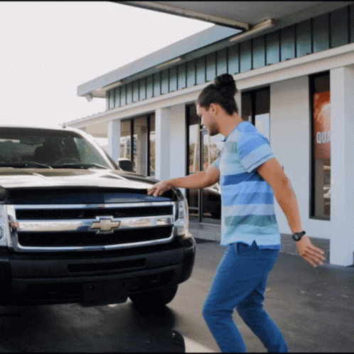 Man Stands in Front of Chevrolet Truck