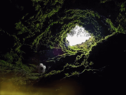 Man Statue Sitting at Table in Dark Cave