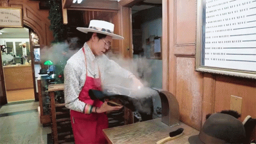 Man Steaming Off Fancy Hat GIF