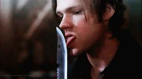 Man Sticking Out Tongue Holding Knife