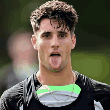 Man Sticking Tongue Out In Black Shirt GIF