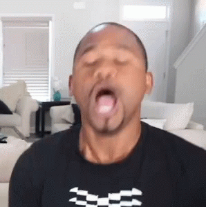 Man Sticking Tongue Out in Black Shirt