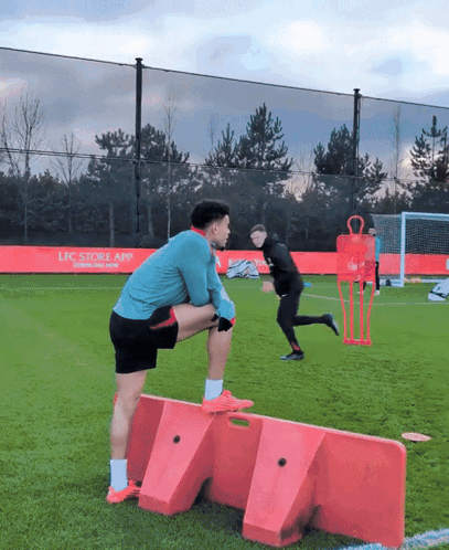 Man Stretching on Soccer Field with LFC App Ad