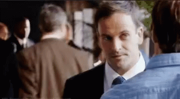 Man Suit Tie Talking to Woman Blue Shirt