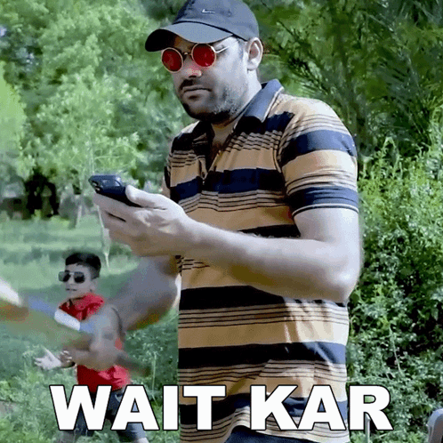 Man Sunglasses Hat Holding Phone Wait Kar