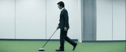 Man Sweep The Ground In The Backyard GIF