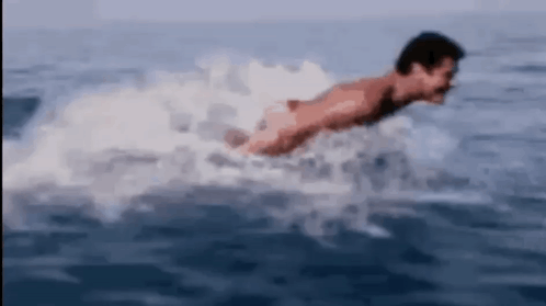 Man Swimming In Ocean Without Shirt GIF
