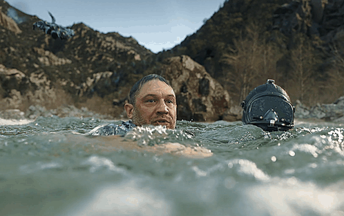 Man Swimming In Water With Helmet GIF