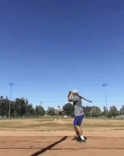 Man Swinging Baseball Bat on Field