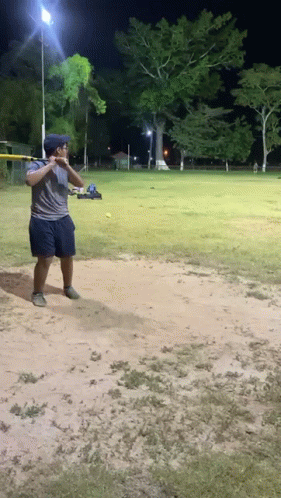 Man Swinging Bat At Ball GIF