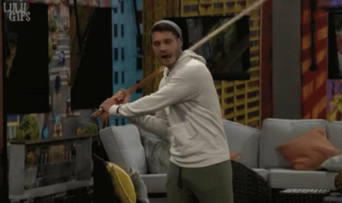 Man Swinging Bat In Living Room GIF