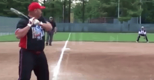 Man Swinging Bat On Baseball Field GIF