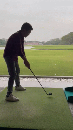 Man Swinging Golf Club