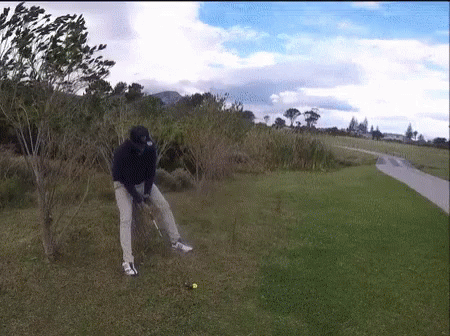 Man Swinging Golf Club At Golf Ball GIF