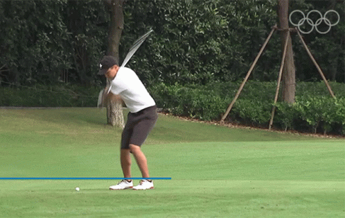 Man Swinging Golf Club