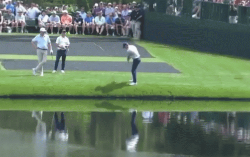 Man Swinging Golf Club