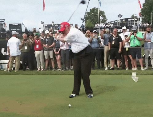 Man Swinging Golf Club in Trump Hat