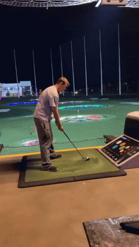 Man Swinging Golf Club