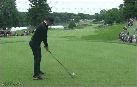 Man Swinging Golf Club