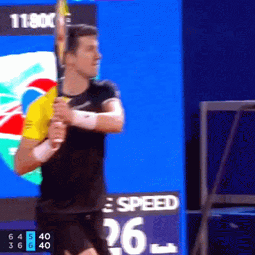 Man Swinging Tennis Racquet in Front of Speed Board