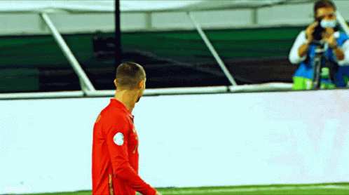 Man Taking Photo of Soccer Player