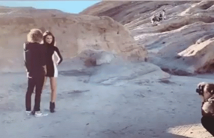 Man Taking Photo Of Woman On Beach GIF