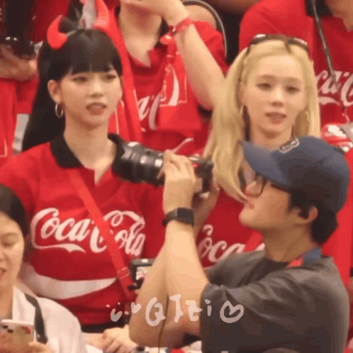 Man Taking Picture of Girl in Red Coca Cola Shirt