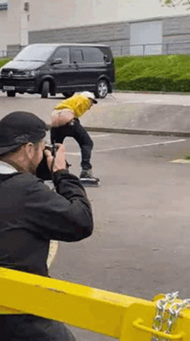 Man Taking Picture of Man on Skateboard