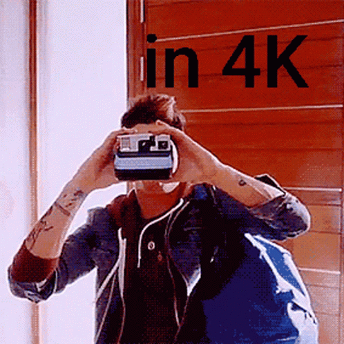 Man Taking Picture With Polaroid Camera In 4K GIF