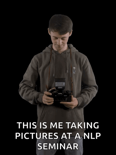 Man Taking Pictures at NLP Seminar With Arms Outstretched