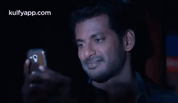 Man Taking Selfie in Dark Room