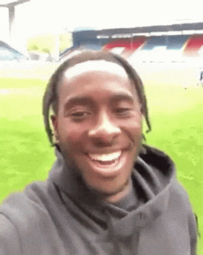 Man Taking Selfie in Front of Soccer Field