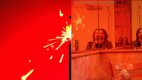 Man Taking Selfie in Mirror With Red Background