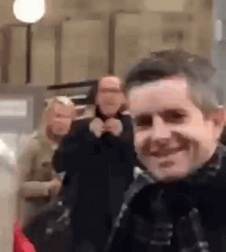 Man Taking Selfie With Group of People