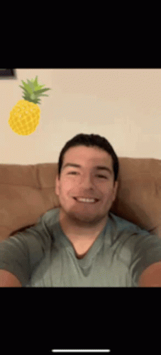 Man Taking Selfie with Pineapple on Head