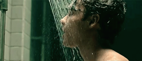 Man Taking Shower With Water Coming Out of Mouth