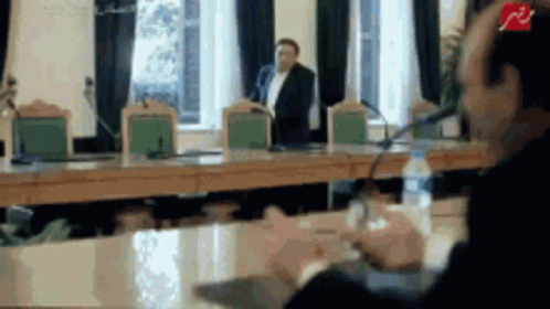 Man Talking Into Microphone, Another Behind GIF
