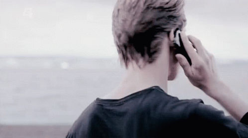 Man Talking On Cell Phone By Ocean GIF