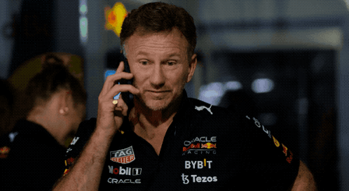 Man Talking on Cell Phone in Red Bull Racing Shirt