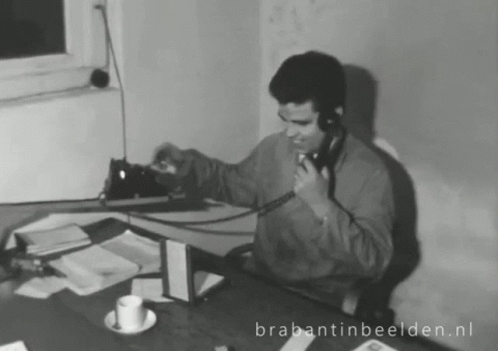 Man Talking On Phone At Desk Brabantinbeelden.nl GIF