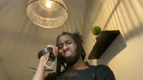 Man Talking On Phone With Belt Around Neck GIF