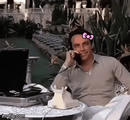 Man Talking on Phone With Hello Kitty Bow on Forehead