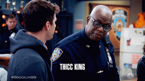 Man Talking to Police Officer With Thicc King Shirt